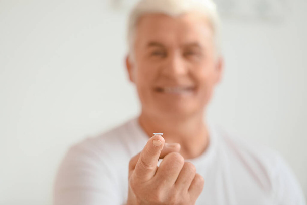 Mature man with contact lens at home - Photo, Image