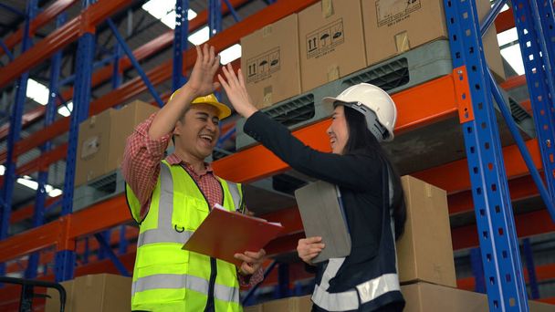 Give me high five. Warehouse worker having fun in the warehouse. - Photo, Image