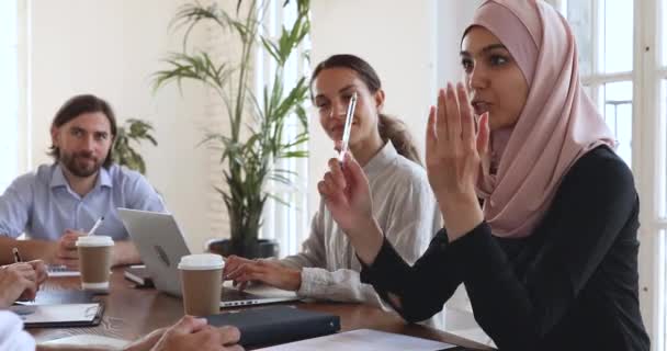 Smiling young arab female employee discussing working issues with colleagues. - 映像、動画