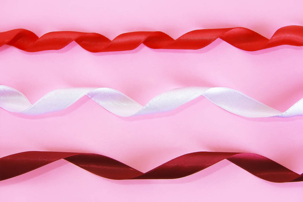 satin decorative white, red, maroon ribbon on pink background - Photo, Image