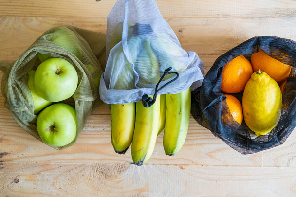 Colorful fresh fruits in eco friendly bags - Valokuva, kuva