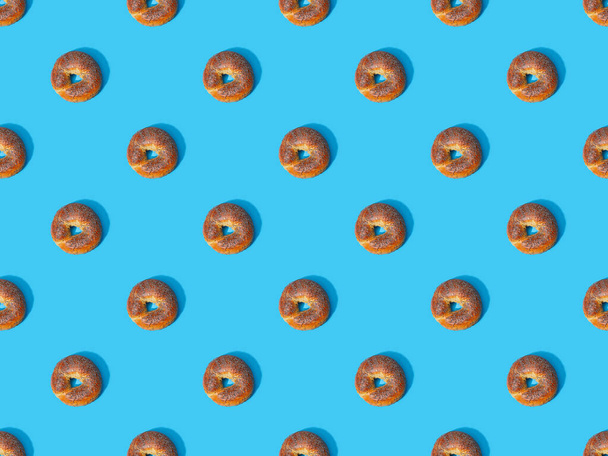 top view of fresh buns on blue background, seamless pattern - Φωτογραφία, εικόνα