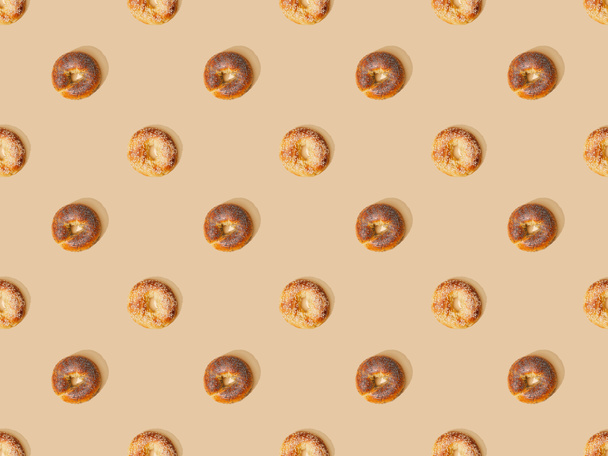 top view of fresh buns on beige background, seamless pattern - Zdjęcie, obraz