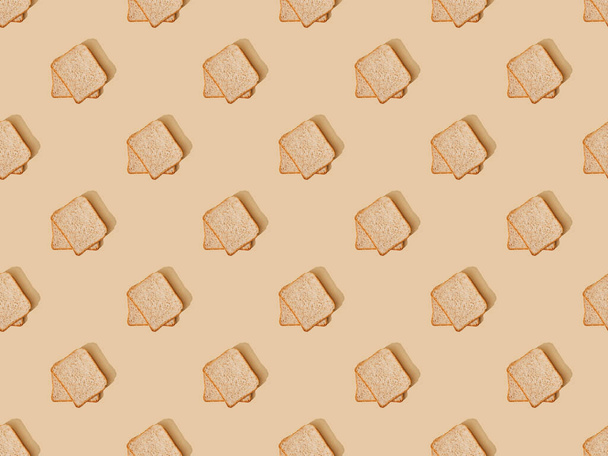 top view of fresh toast bread on beige background, seamless pattern - Foto, Imagem