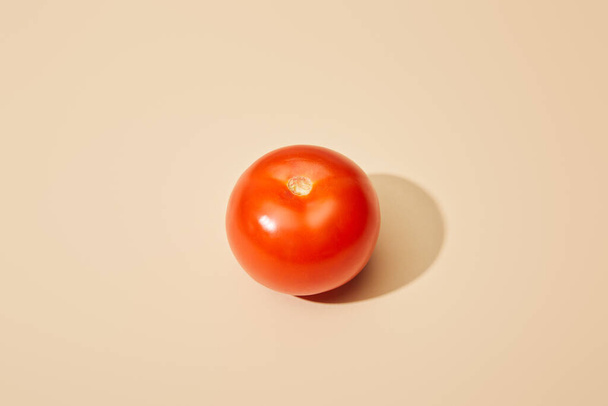 ripe fresh tomato on beige background - Φωτογραφία, εικόνα
