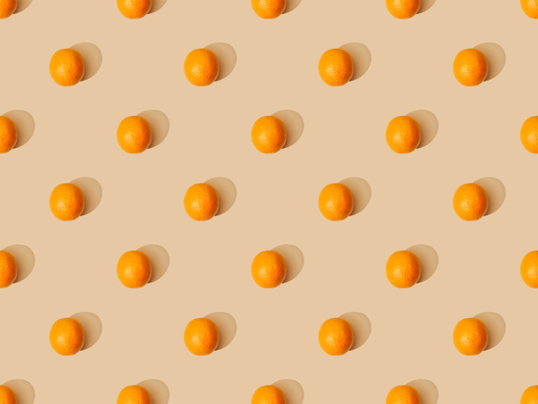 top view of ripe oranges on beige background, seamless pattern - Photo, image