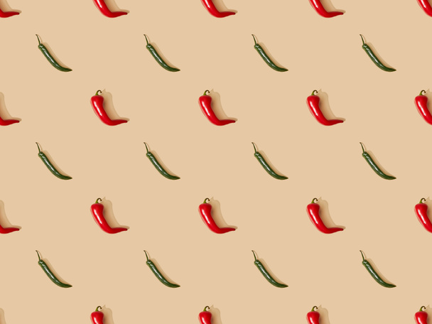 top view of red spicy chili peppers and jalapenos on beige background, seamless pattern - Fotó, kép