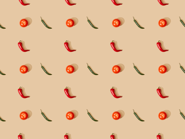 top view of red spicy chili peppers and jalapenos with tomatoes on beige background, seamless pattern - Fotó, kép