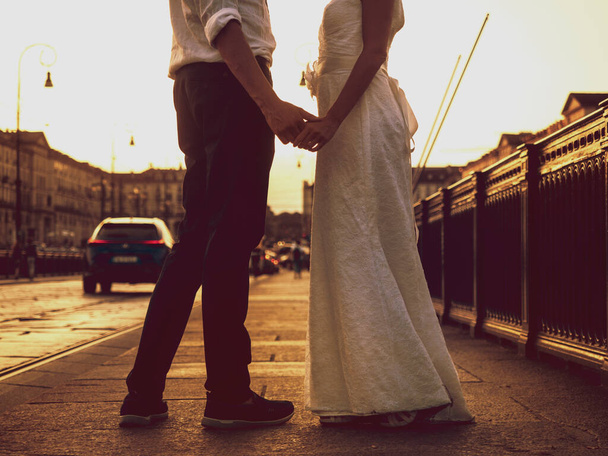newlyweds in town holding hands - Photo, Image