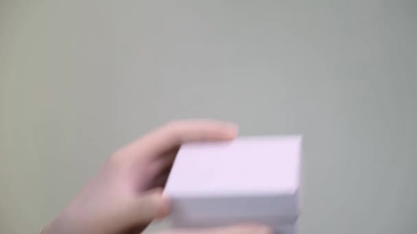 Male Hands in protective latex gloves gives and open empty white gift box. - Πλάνα, βίντεο