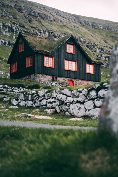 A vertical selective focus shot of Faroese wooden house in Kirkjubour - Фото, изображение