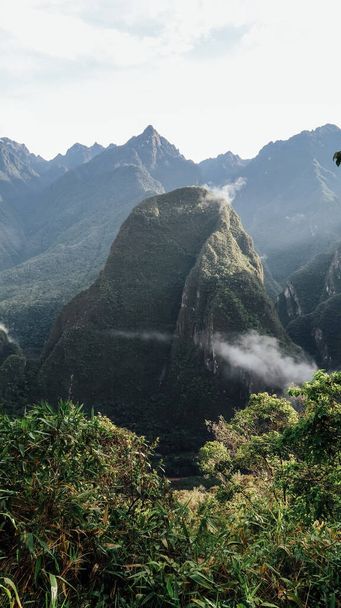 MACHU PICCHU, PERU - CIRCA NOVEMBER 2019: landscapes with green mountains in the clouds on the trail to Machu Picchu lost city. - Foto, Bild