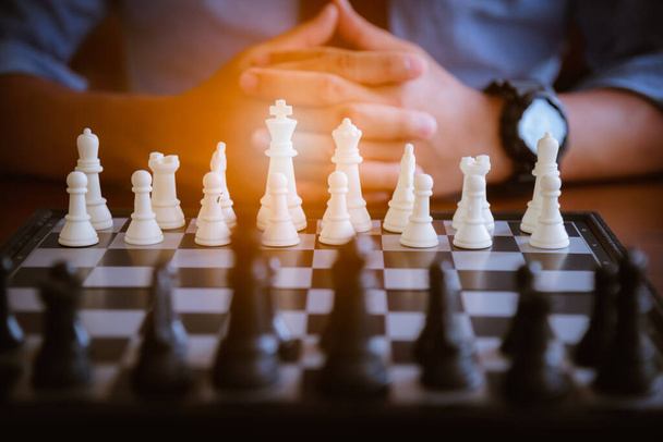 Business mans play chess board game. A white chess team and black chess team  idea for business competition and team work in business concept. - Photo, Image