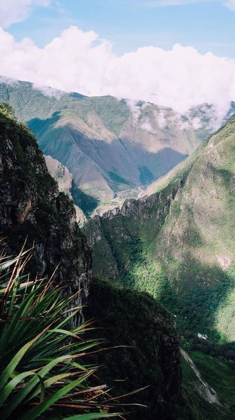 MACHU PICCHU, PERU - CIRCA NOVEMBER 2019: landscapes with green mountains in the clouds on the trail to Machu Picchu lost city. - Фото, изображение