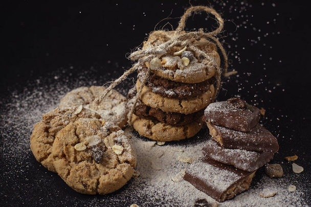 Cookies and chocolate in black - Fotoğraf, Görsel