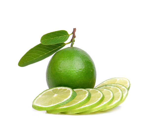Isolated lime slices. Whole and sliced lime fruits with leaves  of white background .lemon high vitamin C.vitamin c for protect virus. - Photo, Image