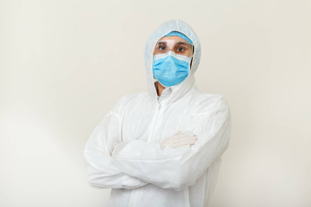 Portret of tired Doctor in protective medical suit, biological hazard, face mask doctor after Coronavirus, covid-19 doctor appointment. Medical healthcare concept. - Foto, afbeelding