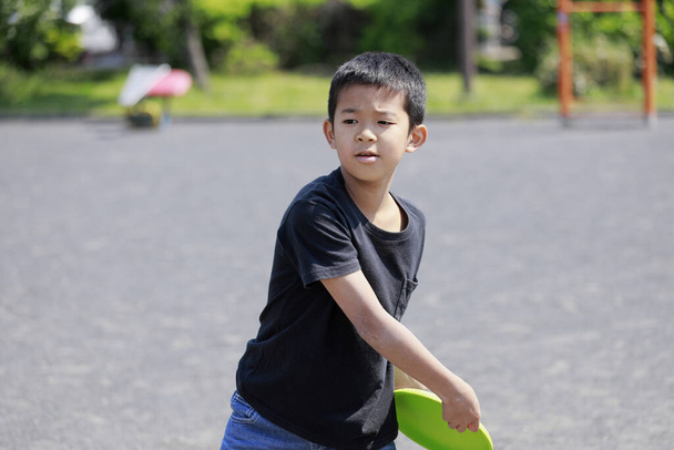 Japanese boy playing flying disc (fifth grade at elementary school) - Photo, Image