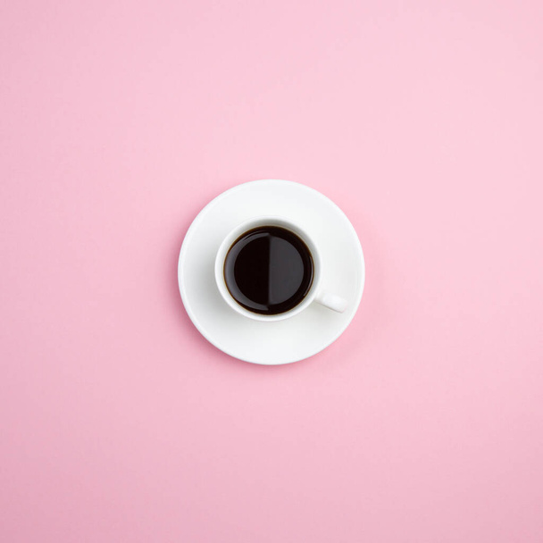 White cup of coffee on pastel pink minimal background. Room for text. Abstract concept. - Valokuva, kuva