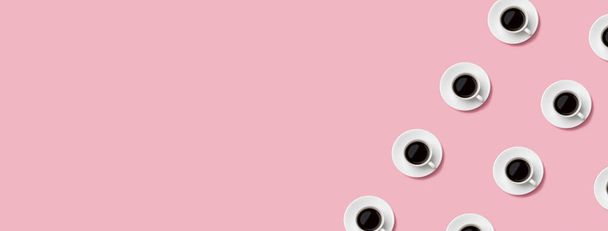 Seamless pattern of black coffee in white cups on pastel pink background. Abstract pop concept. Copy space. - Fotó, kép