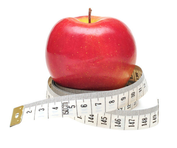 Fita métrica enrolada em torno de maçã vermelha
 - Foto, Imagem