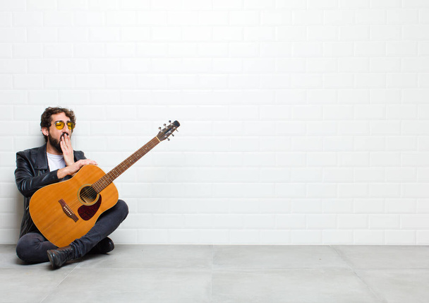 young man with guitar on floor in room - Fotografie, Obrázek