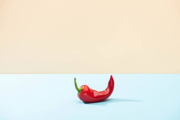 fresh red chili pepper on blue surface isolated on beige - Φωτογραφία, εικόνα