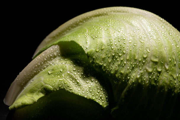 wet fresh cabbage leaves with drops isolated on black - Photo, image