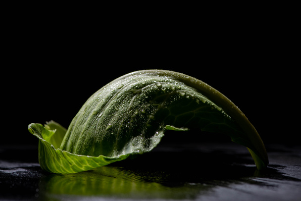 wet green cabbage leaf isolated on black - Foto, afbeelding