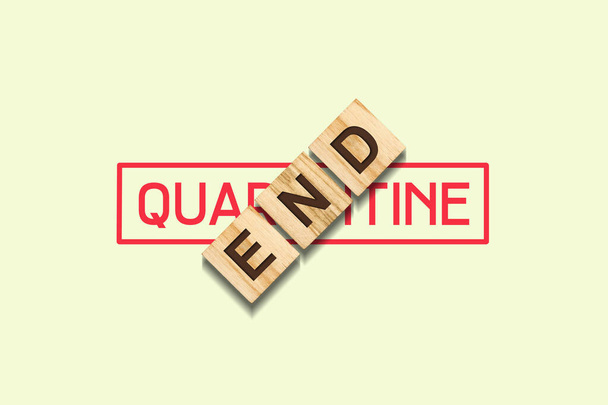 Quarantine End. The inscription on wooden blocks on a green pastel background. The end of the pandemic. Opening a business. - Photo, Image