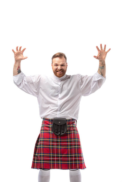 Scottish redhead man in red kilt scaring isolated on white - Photo, Image
