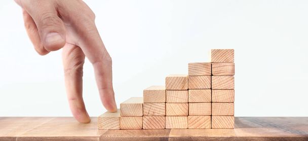 Hand liken person stepping up a toy staircase wood - Photo, Image