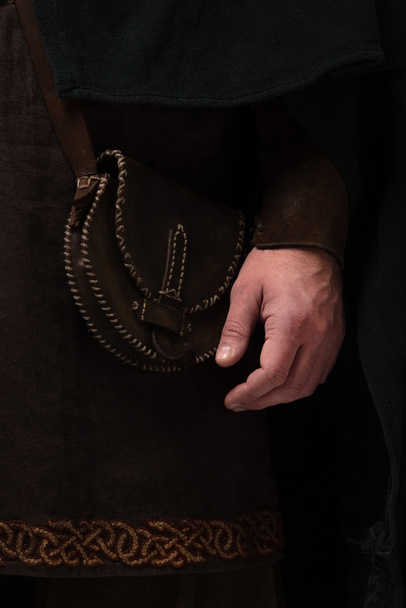 close up view of medieval Scottish man in mantel with leather bag - Foto, immagini