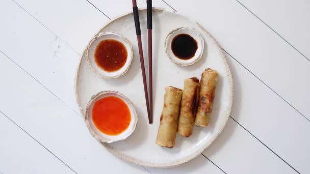 Fried Chinese Thai or Vietnamese traditional spring rolls or nems served on ceramic plate - Footage, Video
