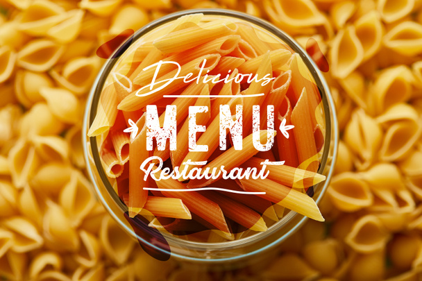 top view of raw penne in jar and around, delicious menu restaurant illustration - Фото, зображення