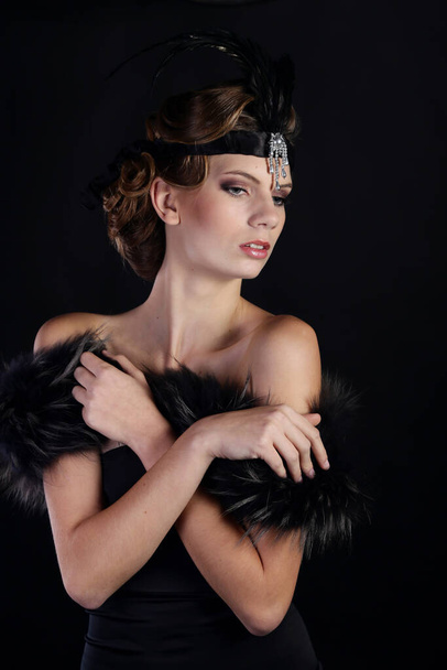 Beautiful woman in the style of Art Nouveau, the era of gangsters. Fashion clothes, make-up and hair in luxurious retro style the roaring 20s. - Photo, Image