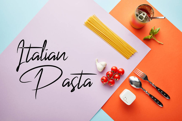flat lay with delicious spaghetti with tomato sauce ingredients on red, blue and violet background with Italian pasta illustration - Photo, image