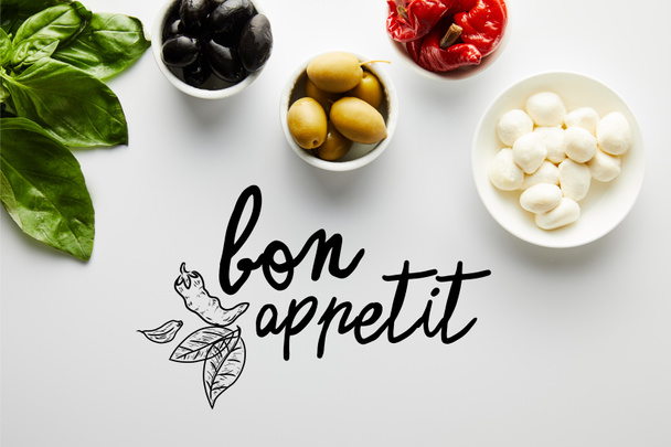 Top view of basil leaves and bowls with ingredients on white, bon appetit illustration - Photo, Image