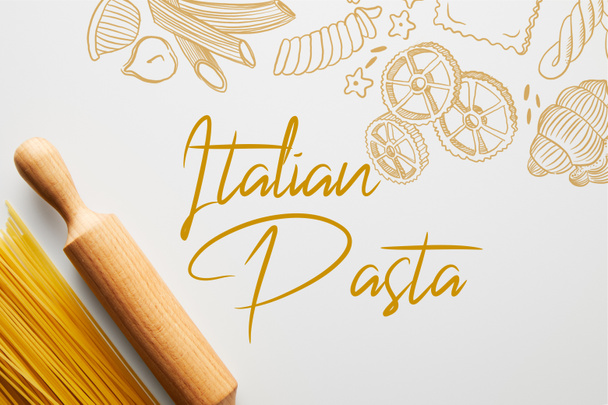 Top view of spaghetti and rolling pin on white background, italian pasta illustration - Zdjęcie, obraz