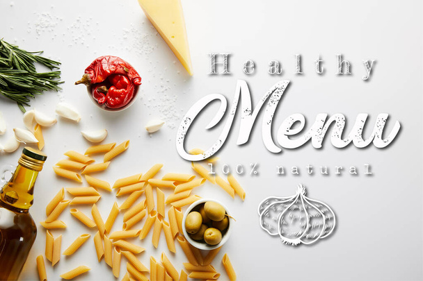 Top view of bottle of olive oil, pasta, cheese and ingredients on white background, healthy menu illustration - Photo, Image