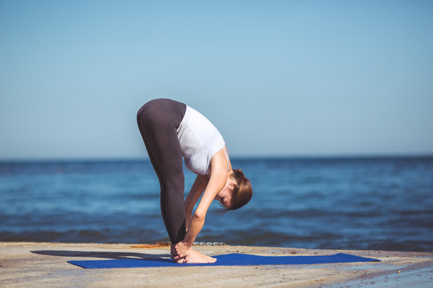 Young woman, sea shore, yoga exercises - Zdjęcie, obraz