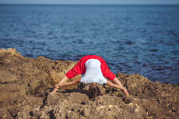Young woman, sea shore, yoga exercises - Фото, зображення