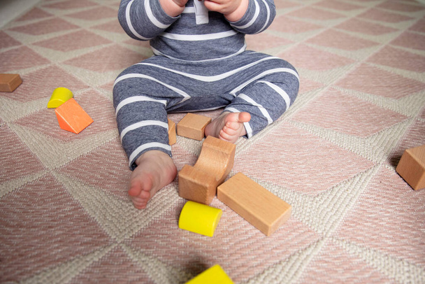 A toddler playing with wooden play blocks in their nursery shot from overhead - Photo, image