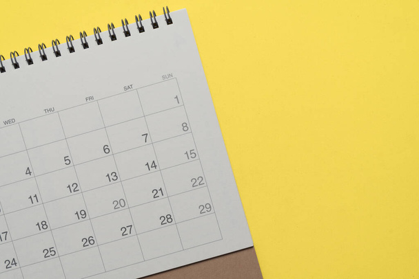 close up of calendar on the yellow table background, planning for business meeting or travel planning concept - Foto, Imagem
