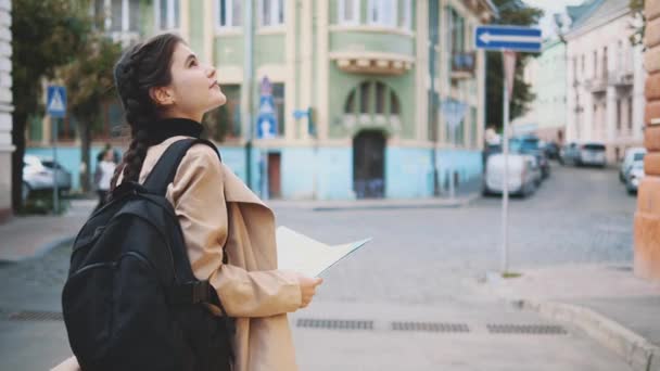 Back view. Attractive young brunette with braids is traveling in Europe and exploring beautiful sightseeing. Close up. Copy space. 4K. - Video, Çekim