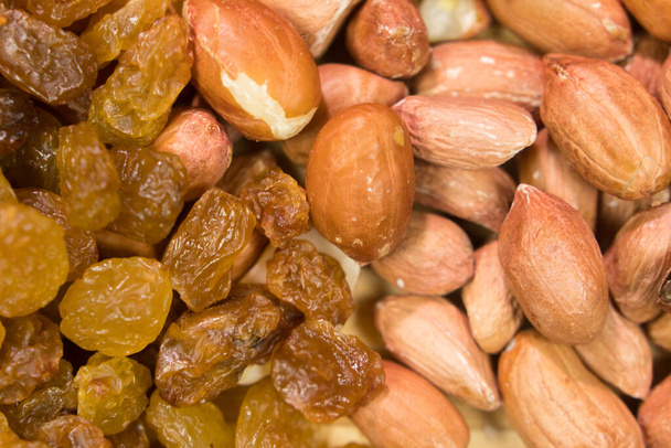 background of mixture of nuts and raisins, closeup - Photo, Image