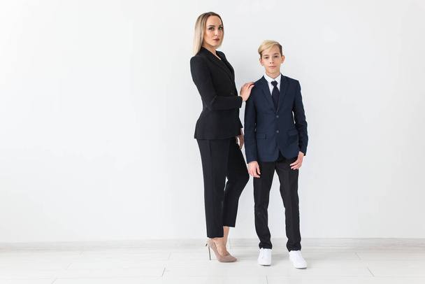 Parenting, family and single parent concept - A happy mother and teen son smiling on white background. - 写真・画像
