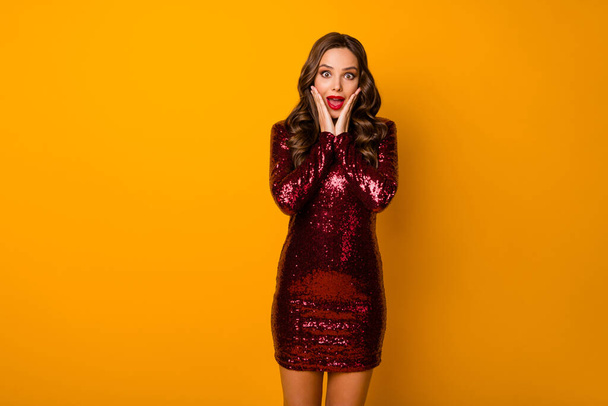 Portrait of astonished positive energetic girl look good wonderful discount novelty impressed scream touch hands face wear burgundy clothes isolated over bright color background - Foto, imagen