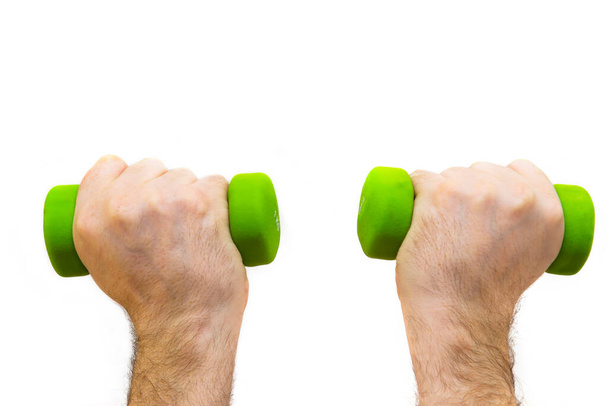 Erkek, iki kolu da yeşil bir halterle kaldırılmış. Beyaz arka plan. Spor ve sağlık konsepti. - Fotoğraf, Görsel