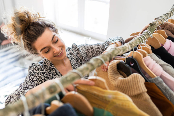 Young woman choosing clothes - Foto, imagen
